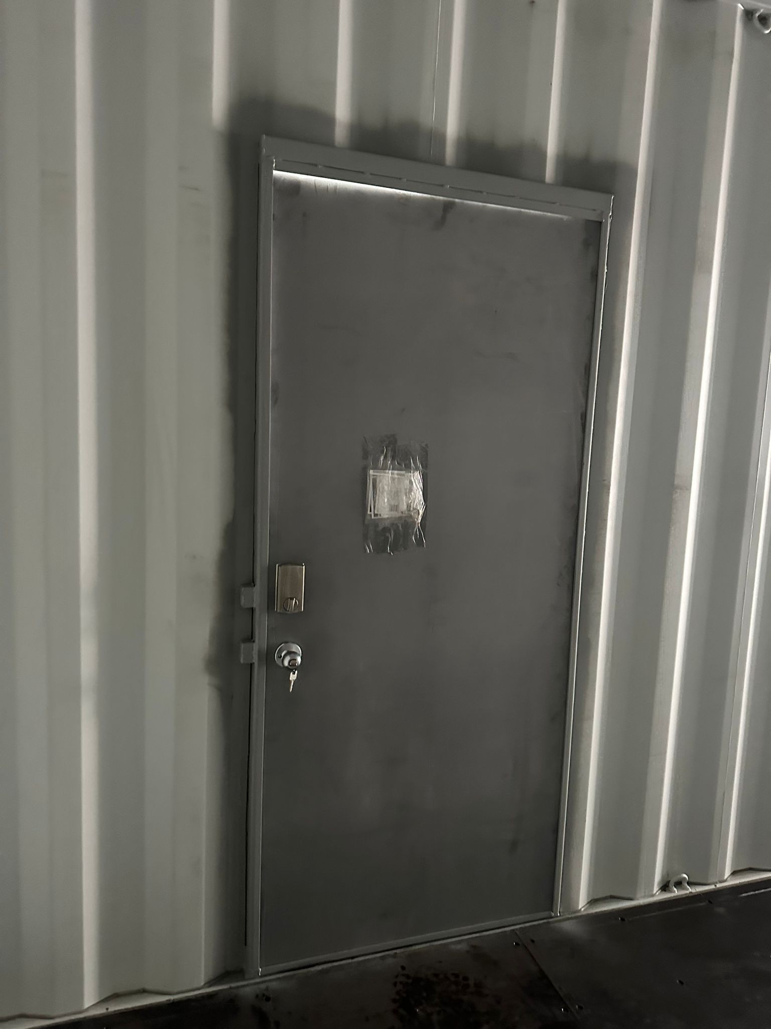 Custom personnel door installed in shipping container interior by Lyonheart Containers Ontario