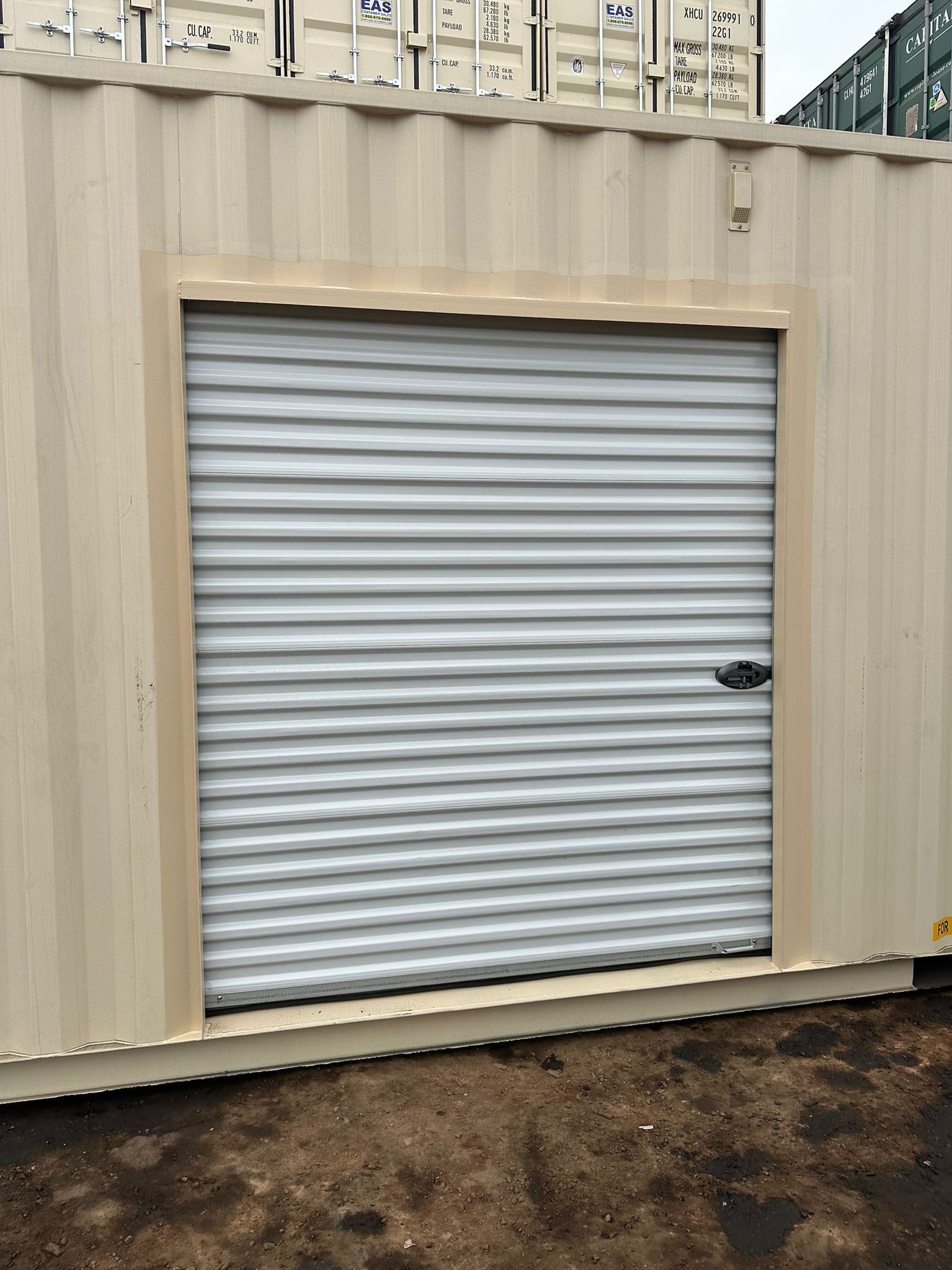 Custom roll-up door installed in side of shipping container by Lyonheart Containers Ontario